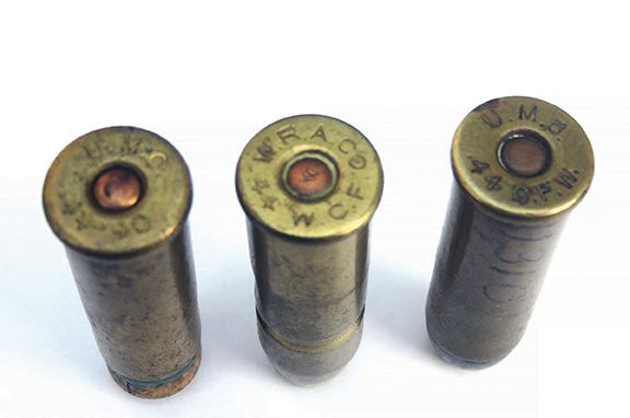 Three very old 44-40 cartridges; the one on the left is a shot load with a wooden bullet.
